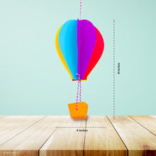 Load image into Gallery viewer, This picture shows The Kids Craft&#39;s Cherish the Rainbow Craft Kit - 3D Hot Air Balloon that your kid will be able to create once they are done.  Let your kid be a creator with this Craft Kit Box - The Kids Craft, a Creativeana LLC company creation. Your kid will love The Kids Craft&#39;s Cherish The Rainbow Crafts as they create their own hot air balloon, decorate their rainbow, create a bracelet, and create their art masterpiece.
