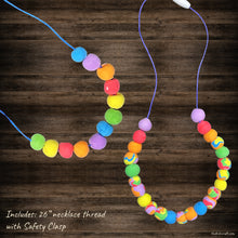 Load image into Gallery viewer, This picture shows The Kids Craft&#39;s Cherish the Rainbow Craft Kit - Rainbow Necklace that your kid will be able to create once they are done. Let your kid be a creator with this Craft Kit Box - The Kids Craft, a Creativeana LLC company creation. Your kid will love The Kids Craft&#39;s Cherish The Rainbow Crafts as they create their own hot air balloon, decorate their rainbow, create a bracelet, and create their art masterpiece.
